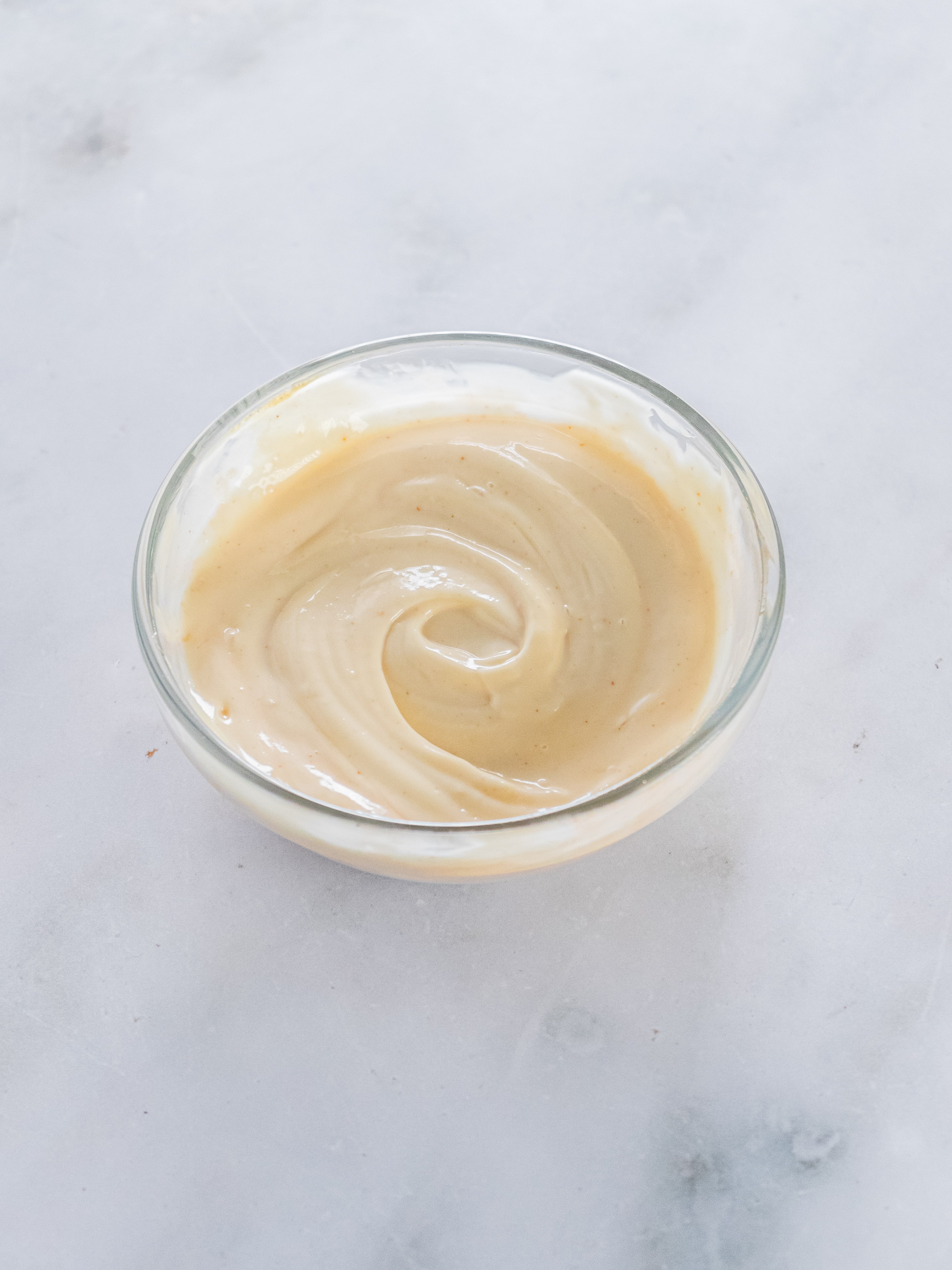 Image of Stir together ingredients for spicy remoulade in a small bowl....