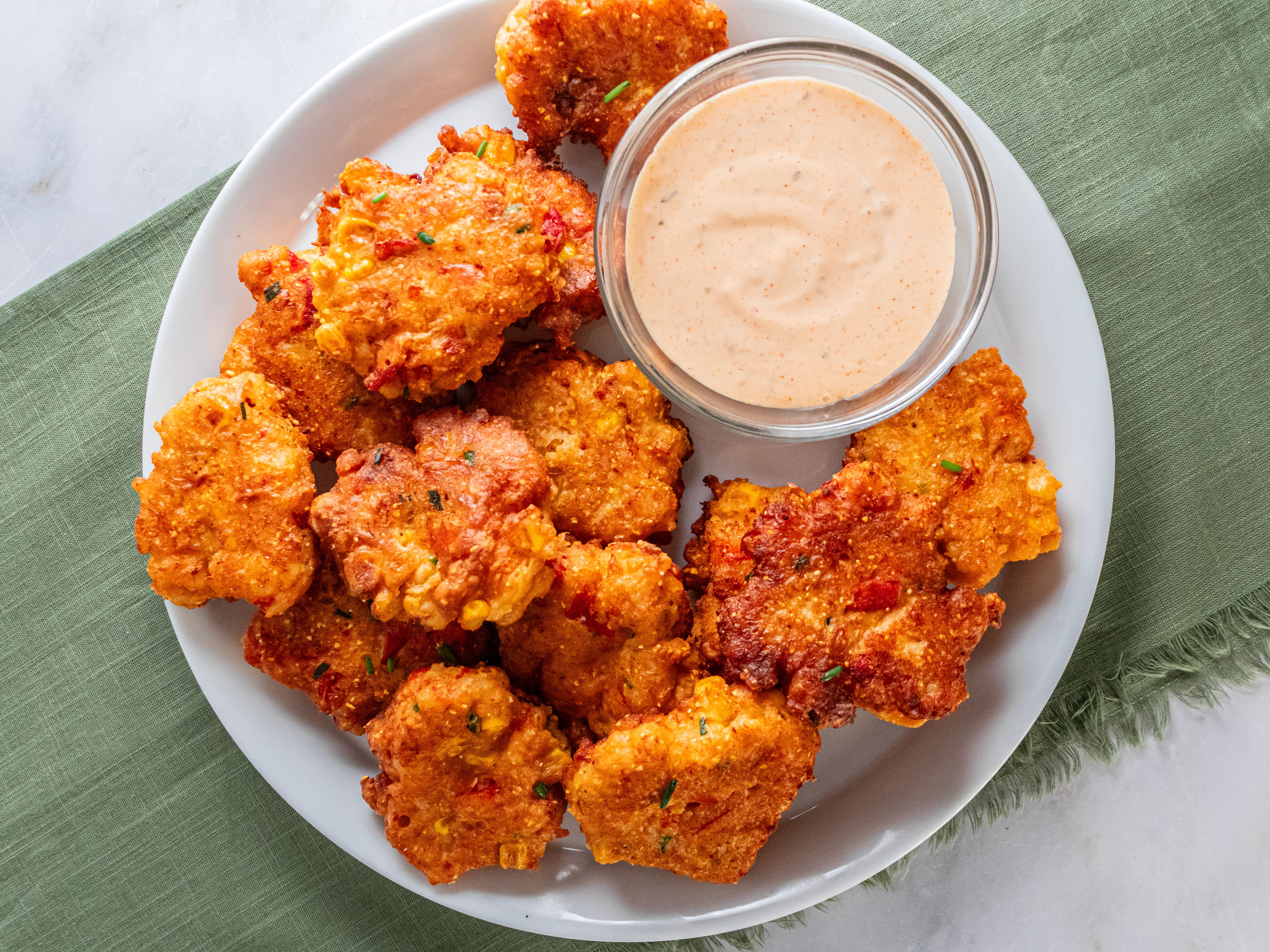 Image of Transfer cooked lobster corn fritters to baking sheet and transfer...