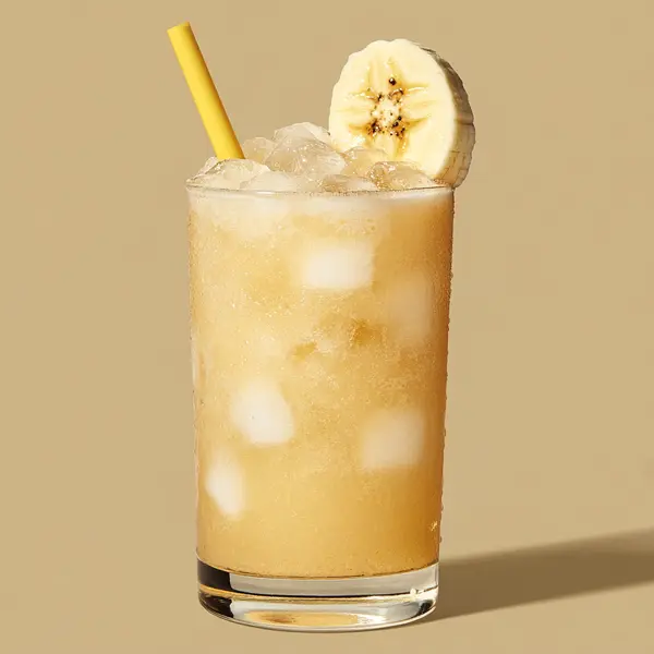 A photo of the Bananacana Smoothie cocktail containing Novo Fogo Chameleon Cachaça, Banana (peeled), Condensed milk in a Collins.