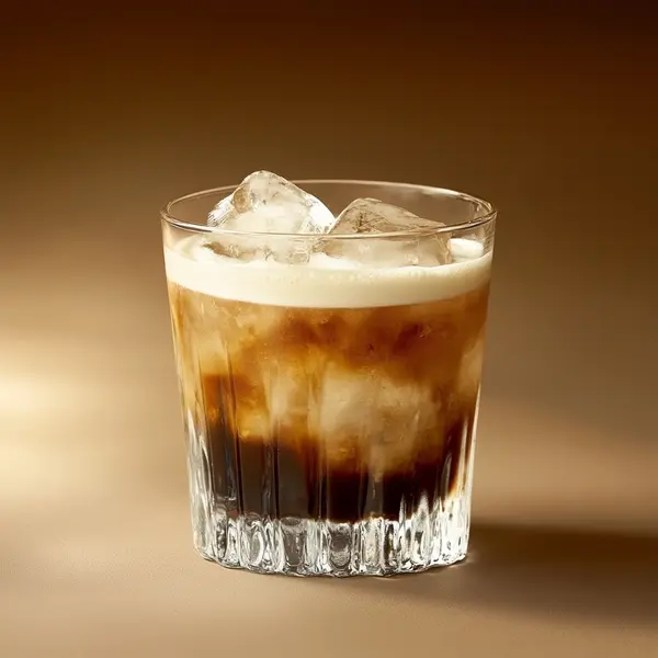 A photo of the Golden Espresso Splash cocktail containing Flor de Caña 4 Year Old Añejo Oro Rum, Mr Black Cold Brew Coffee Liqueur, Romana Black Sambuca Liqueur, Single cream / half-and-half, Milk in a Old-Fashioned.