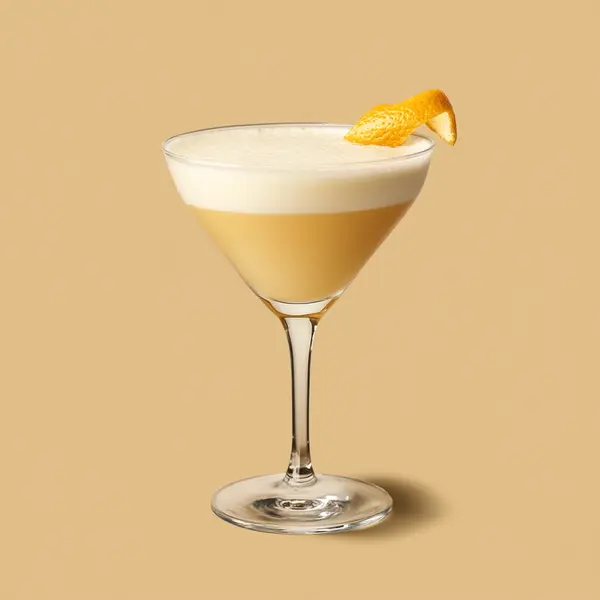 A photo of the Sunset Elixir cocktail containing Hennessy V.S. Cognac, Licor 43 Spanish Liqueur, Freshly squeezed orange juice, Milk, Single cream / half-and-half in a Martini.