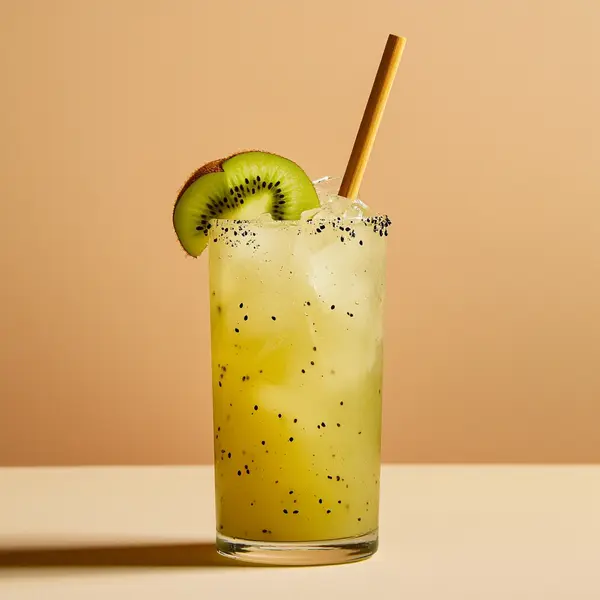A photo of the Kiwi Carnival Cooler cocktail containing Fresh lime (chopped wedges), Caster sugar, Kiwi fruit, Ricard Pastis de Marseille Aperitif, Pressed apple juice, Novo Fogo Chameleon Cachaça in a Highball.