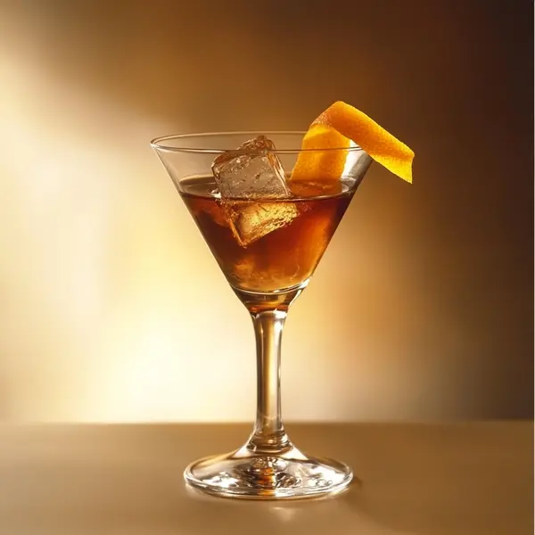 A photo of the Maple Manhattan cocktail containing Savage & Cooke Cask Finished Bourbon, Angostura Aromatic Bitters, Maple syrup in a Martini.