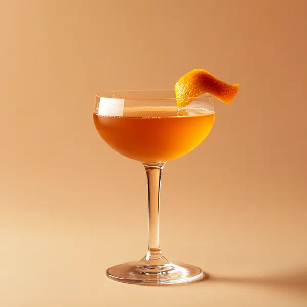 A photo of the Orangecraft Martini cocktail containing Beefeater London Dry Gin, Noilly Prat Dry Vermouth, Pierre Ferrand Dry Curaçao, Angostura Orange Bitters in a Coupe.