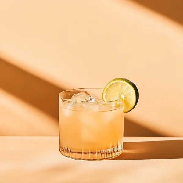 A photo of the Honey Admiral cocktail containing Hamilton Navy Strength 114 Proof Rum, Runny honey, Freshly squeezed lime juice, Angostura Aromatic Bitters, Chilled water in a Old-Fashioned.