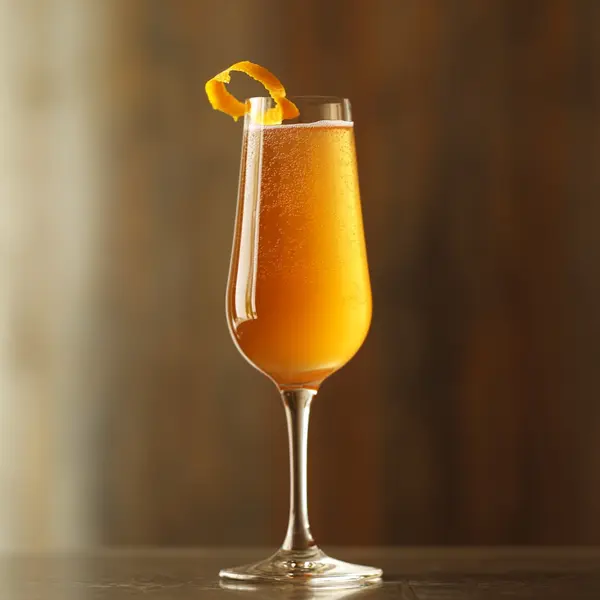A photo of the Honey Rhubarb Fizz cocktail containing Rhubarb & orange preserve, Roots Rakomelo Sweet Liqueur, La Marca Prosecco in a Flute.
