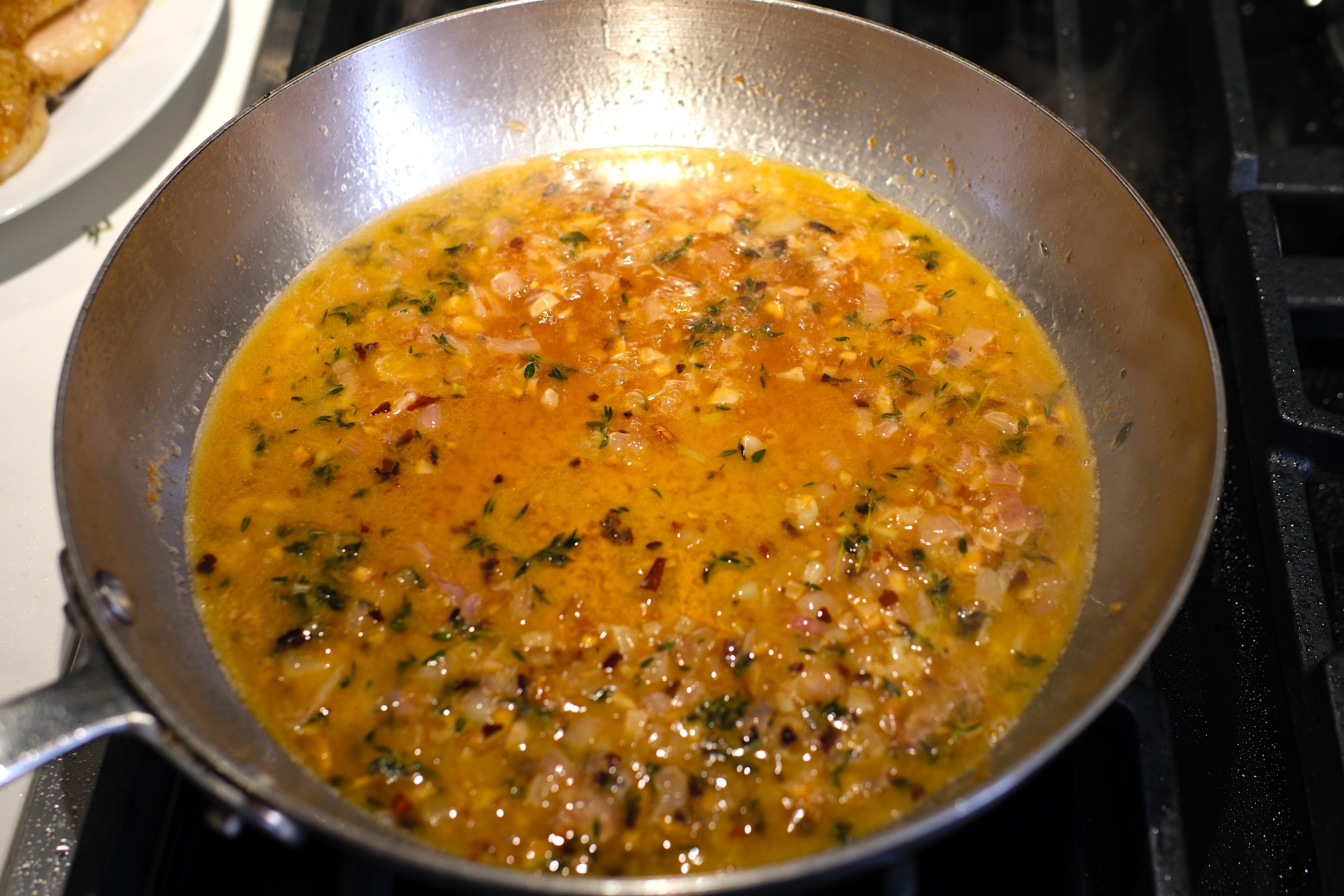 Image of Add wine and vinegar to the pan and scrape to...