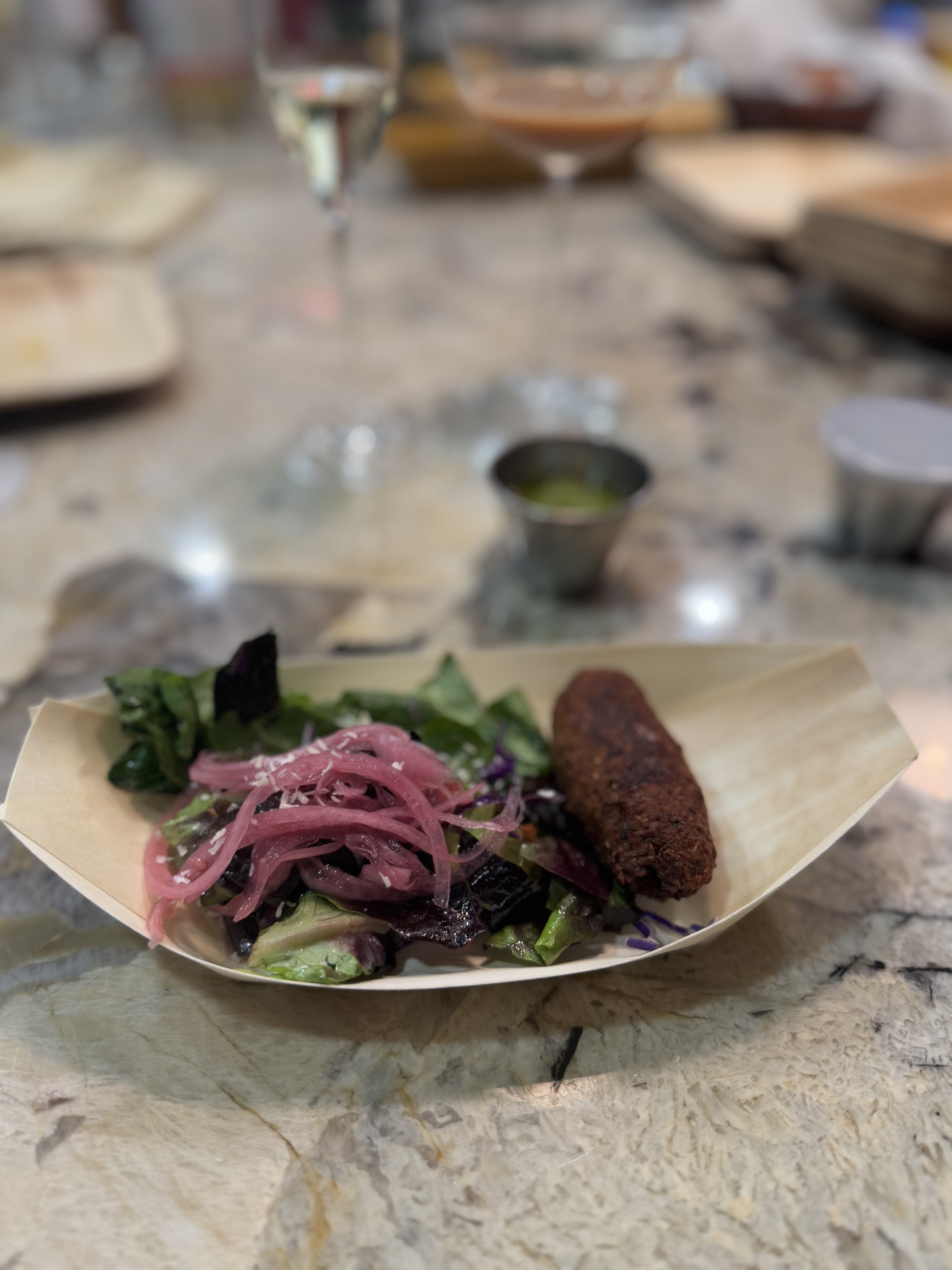 Image of Serve with salad, pickled onions, corn kebab and chutney.