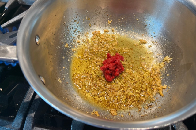 Image of Add the tomato paste and stir until the color deepens....