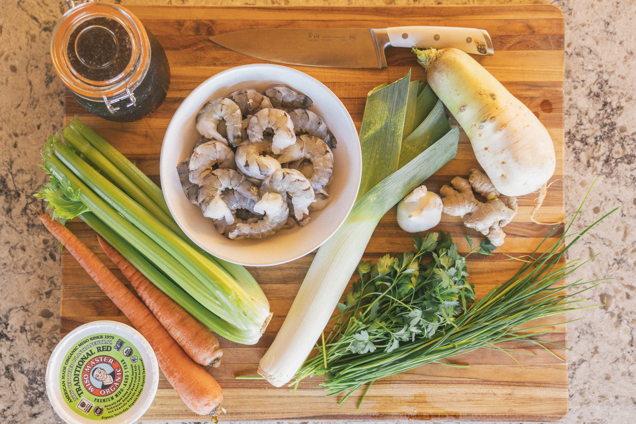 Image of Add ginger, garlic, leek, celery, daikon, and carrot.