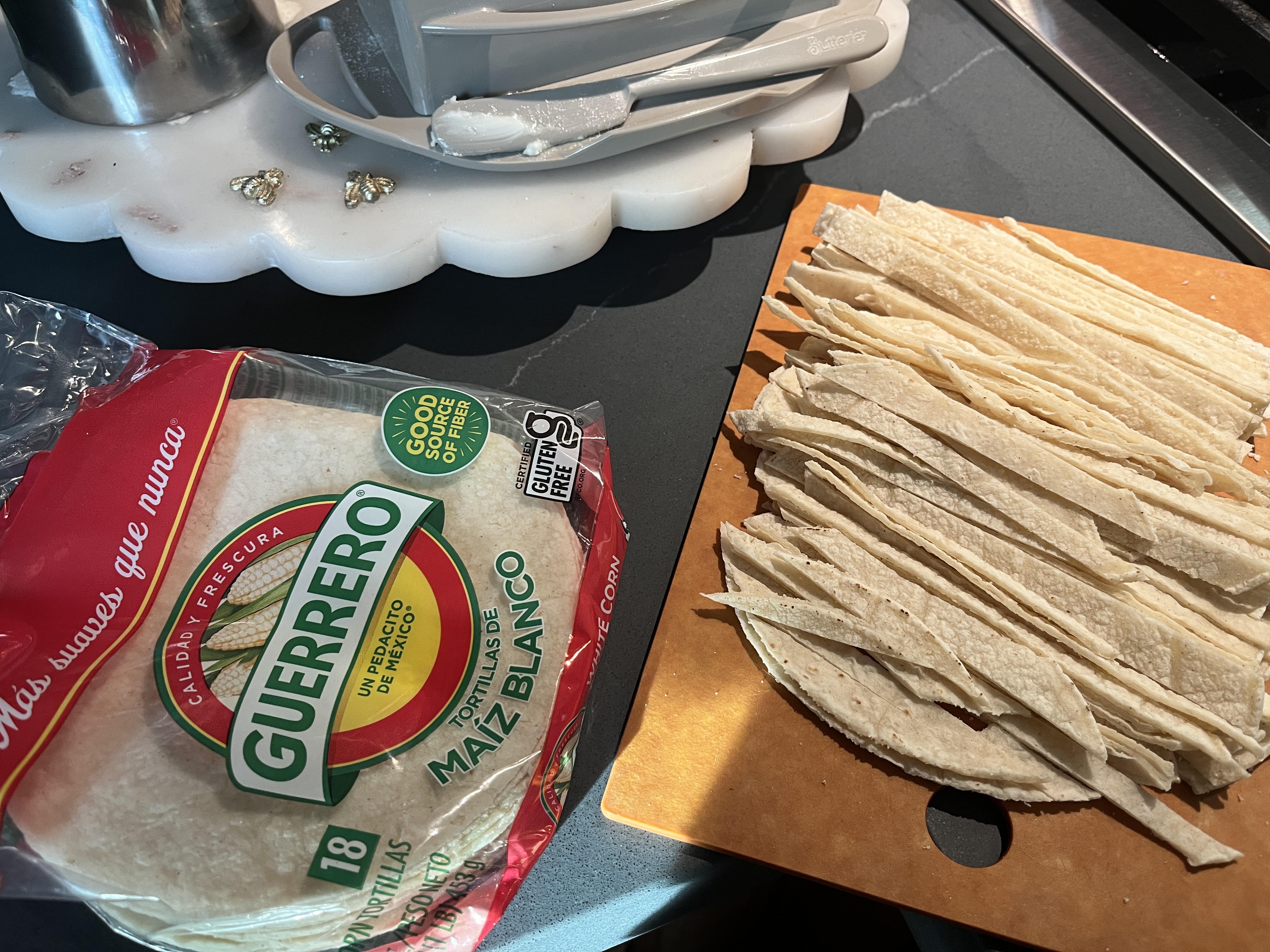 Image of Stack fresh corn tortillas and cut into thin strips. Cut...