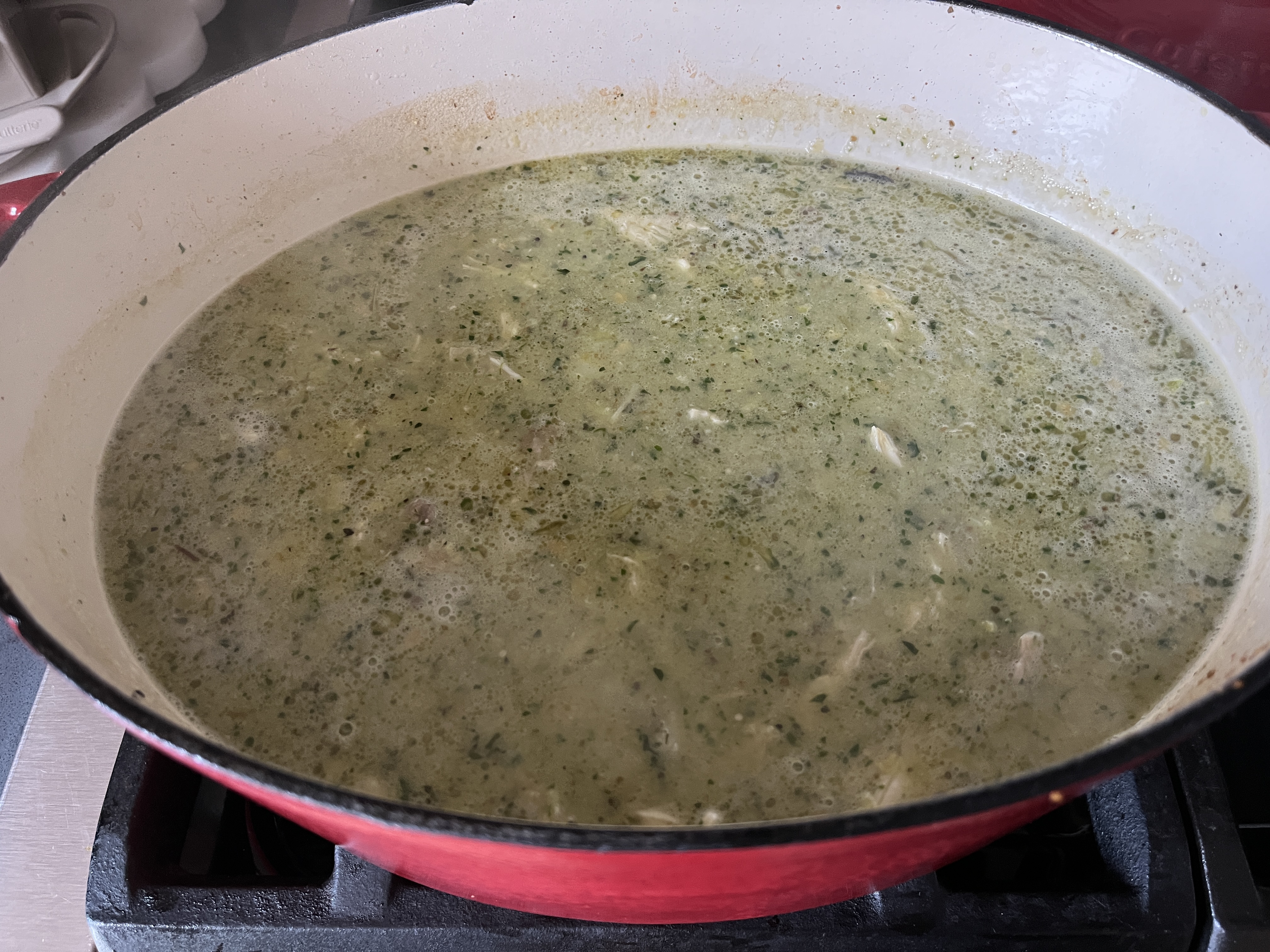 Image of Add the hominy, chicken stock and shredded chicken and season...