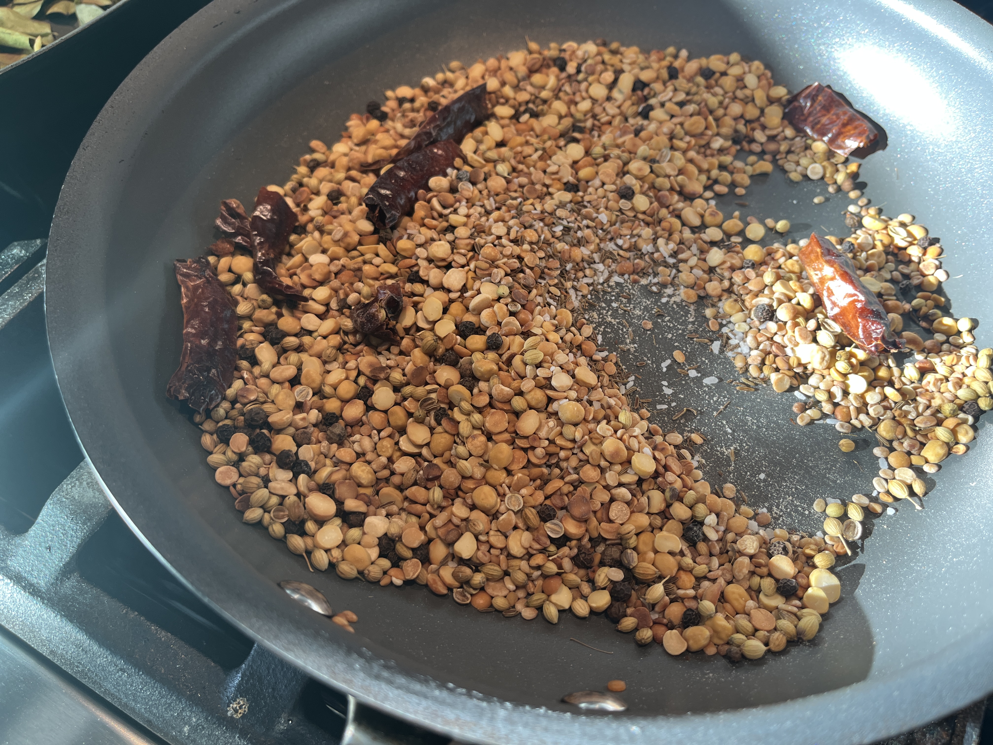 Image of In a pan over medium heat, dry roast chana, urad,...