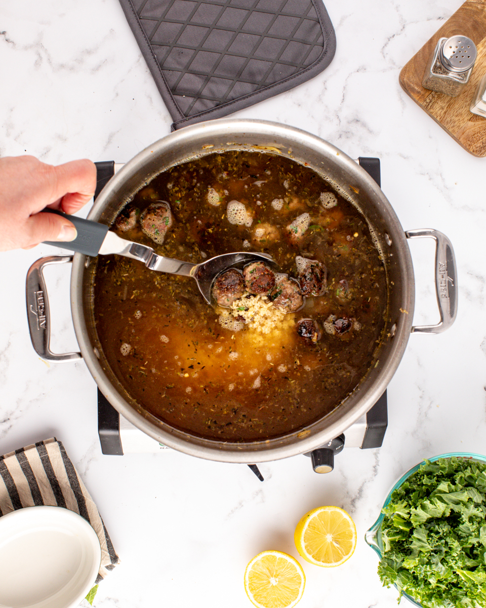 Image of Add broth, reserved meatballs to the pot. Bring the mixture...