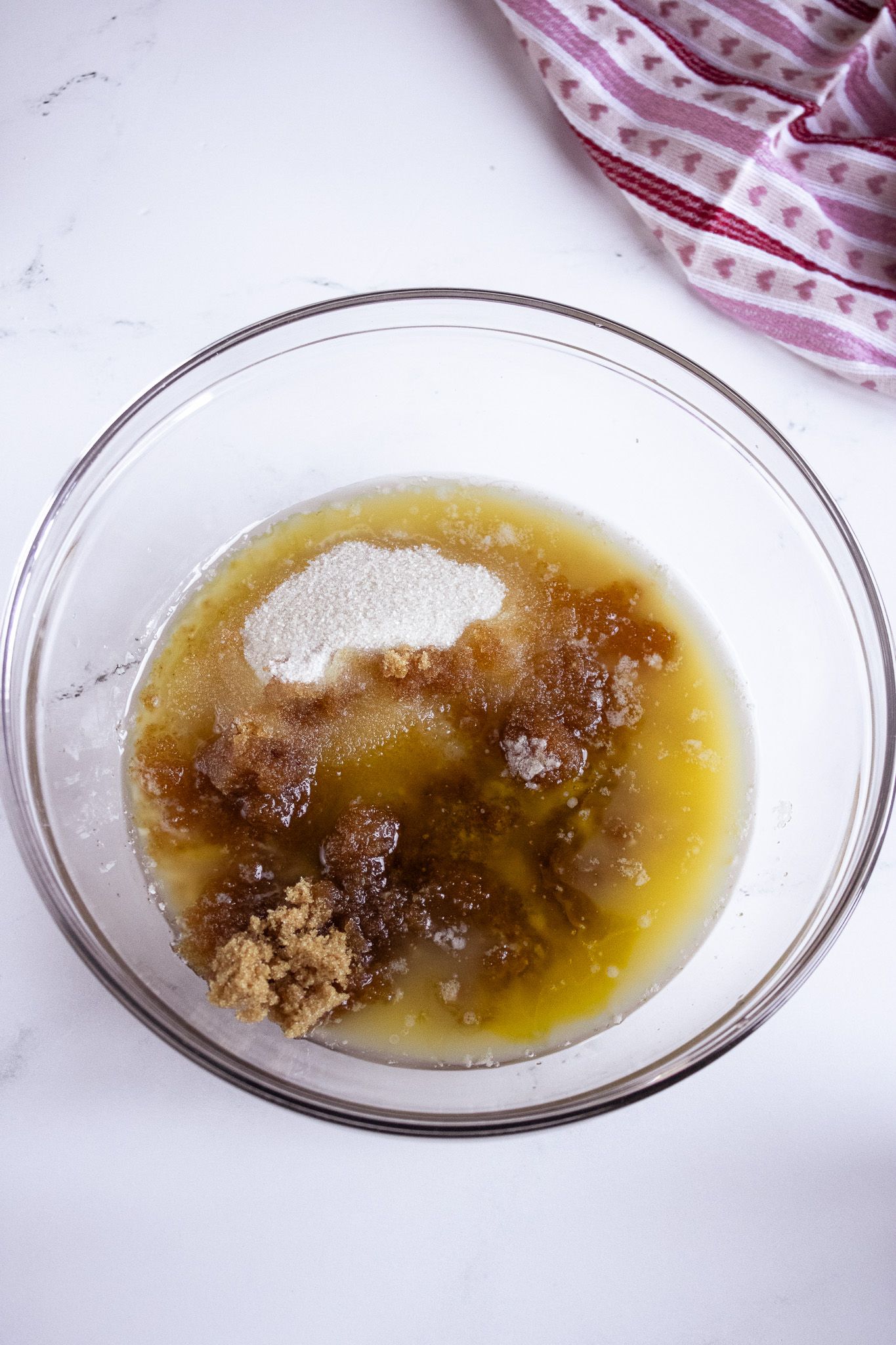 Image of Mix together melted butter, oil, and sugars. Mix until combined.