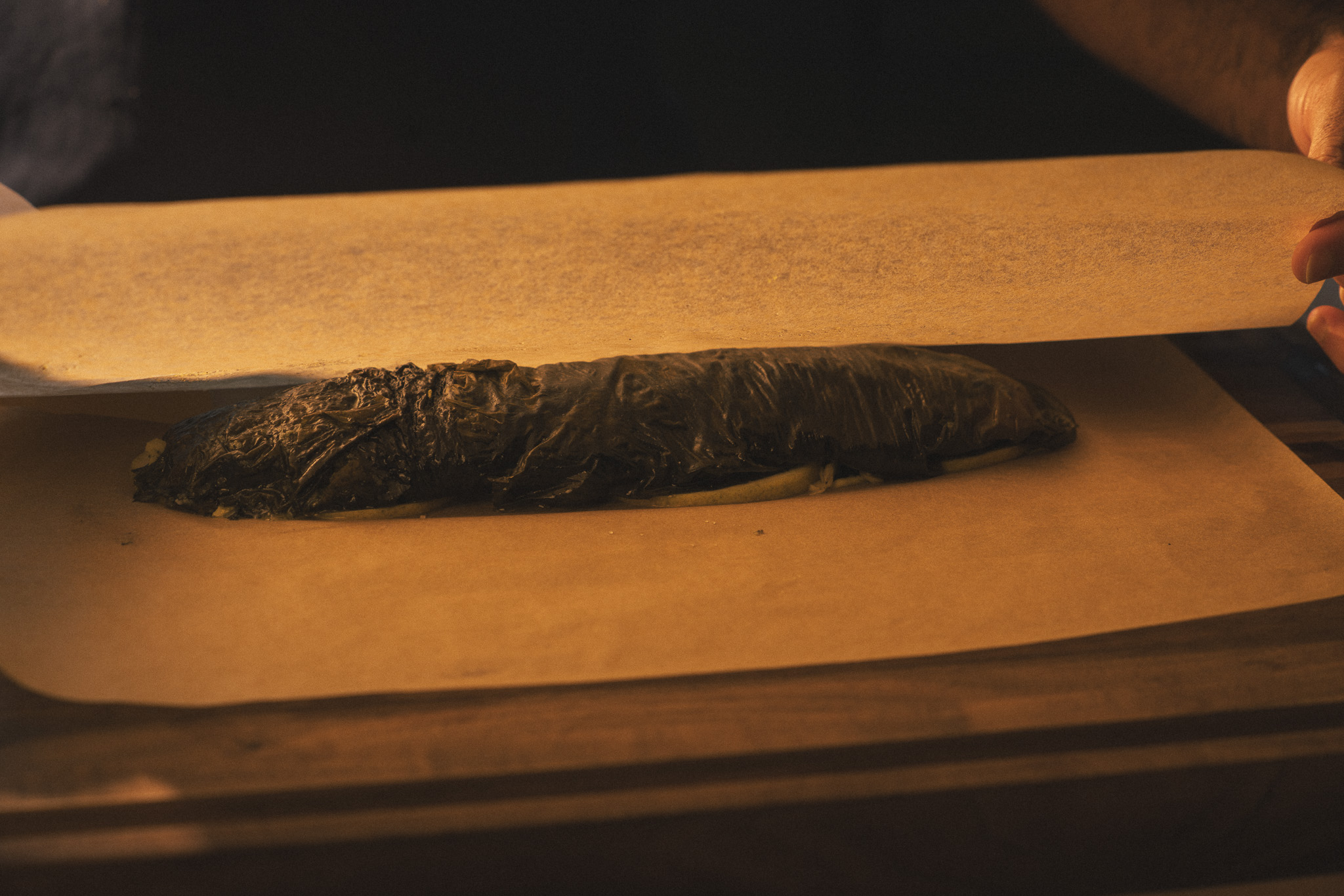 Image of Seal the papillote:Lay the second piece of parchment over the...