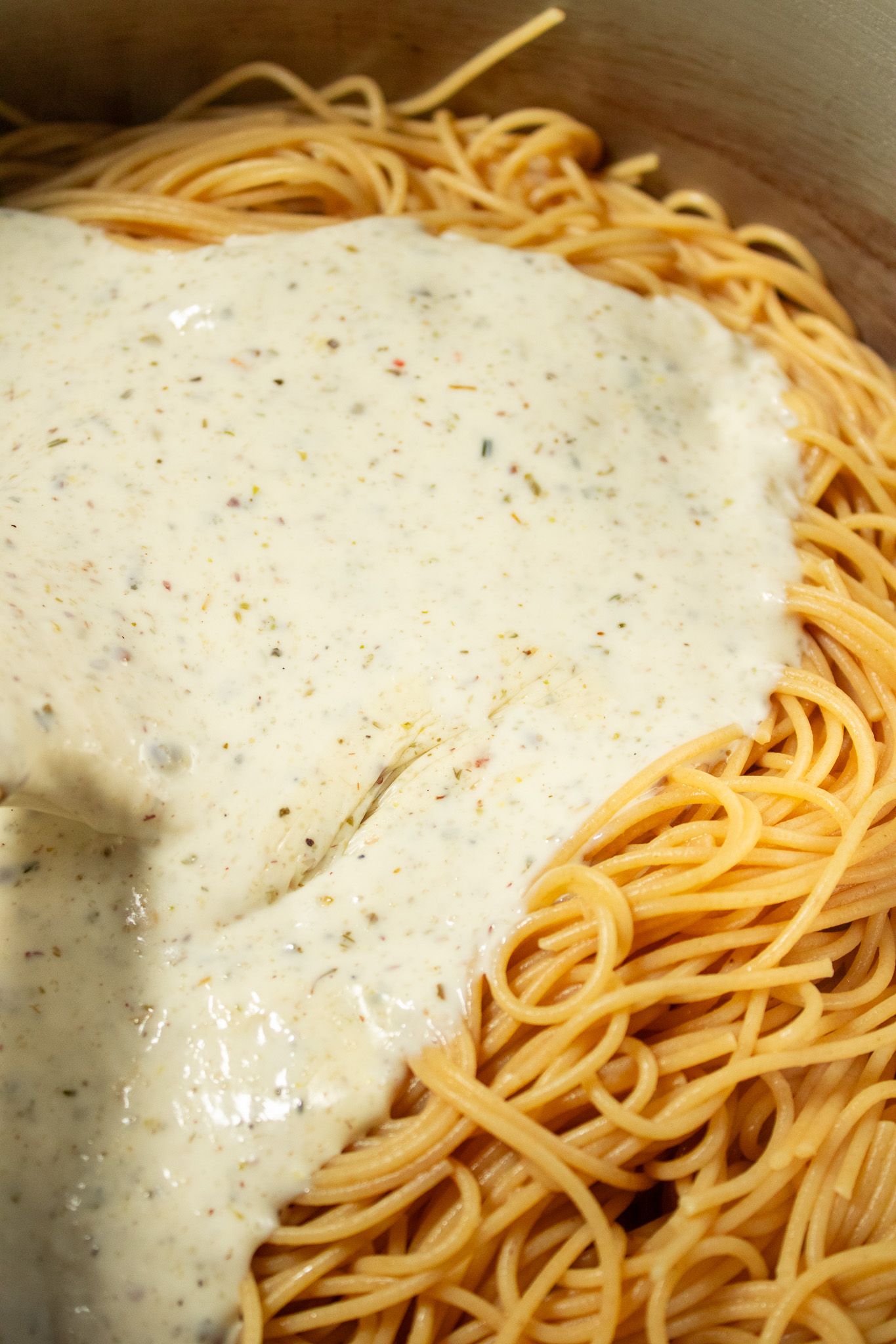 Image of Add sauce to pasta and mix gently.