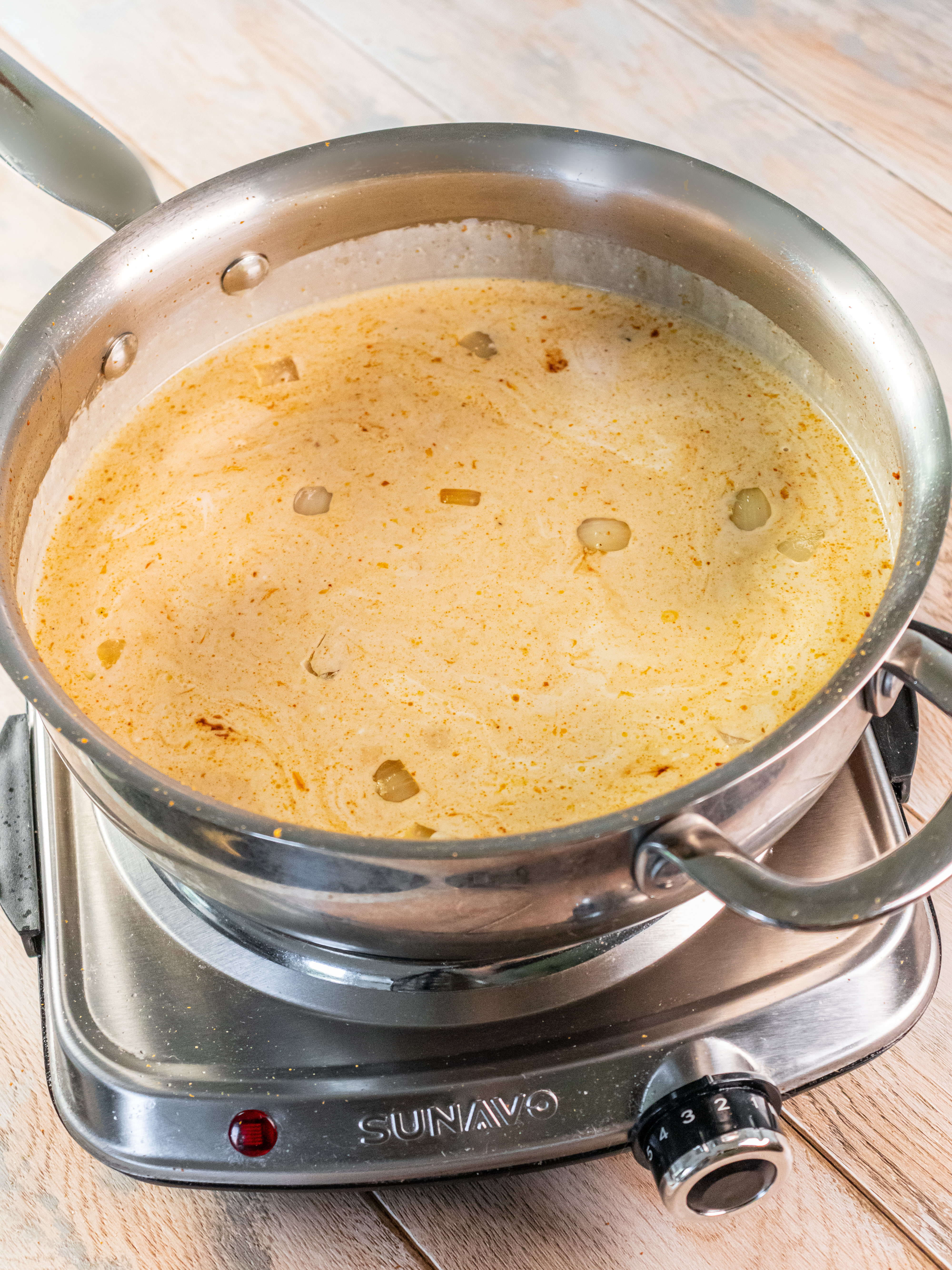 Image of Pour in the coconut milk and broth, stir well to...