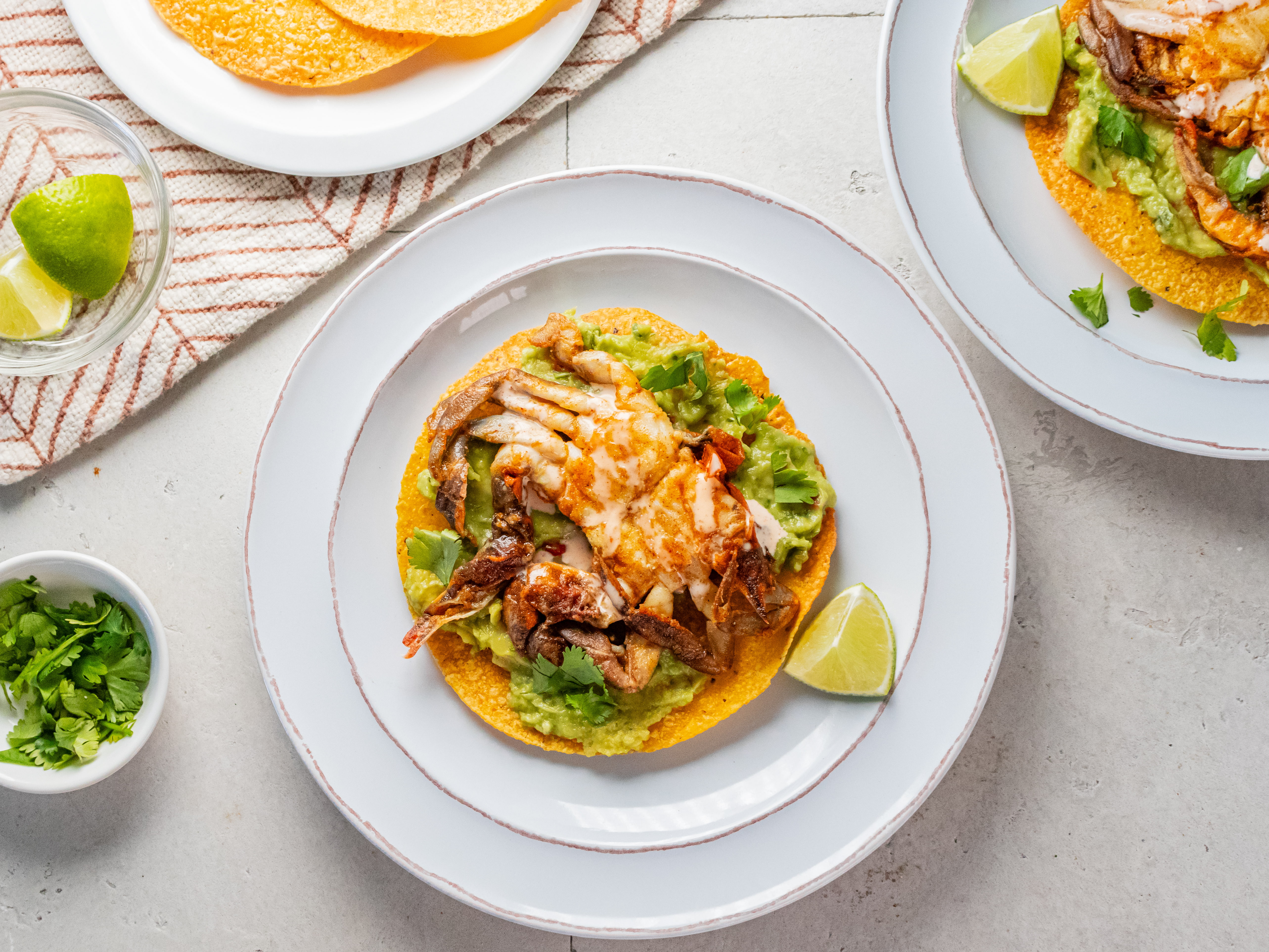 Image of Spread a generous spoonful of guacamole on each tostada shell....
