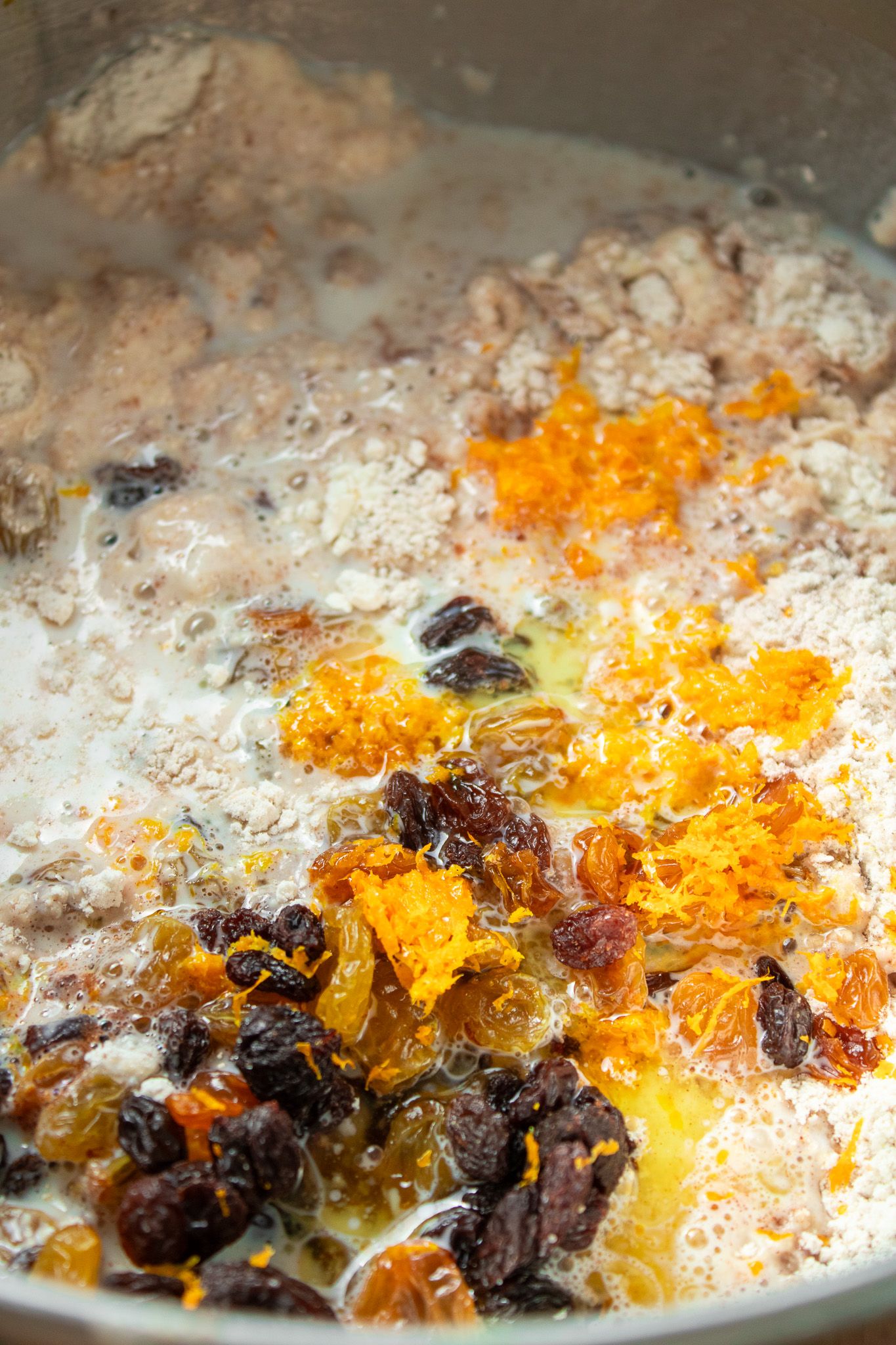 Image of Add in the melted butter, milk eggs, raisins and orange...