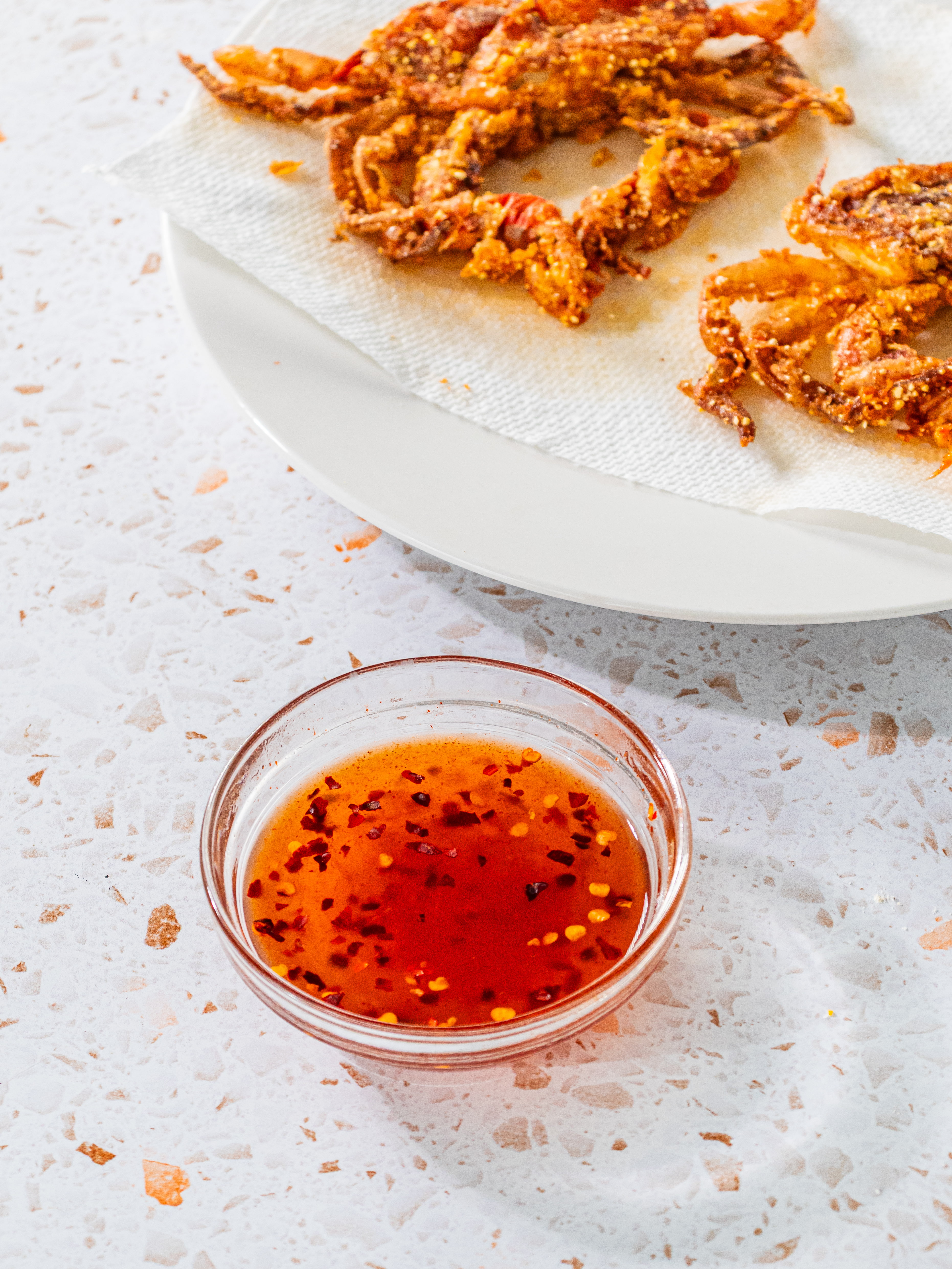 Image of Stir together honey, hot sauce, and red pepper flakes in...