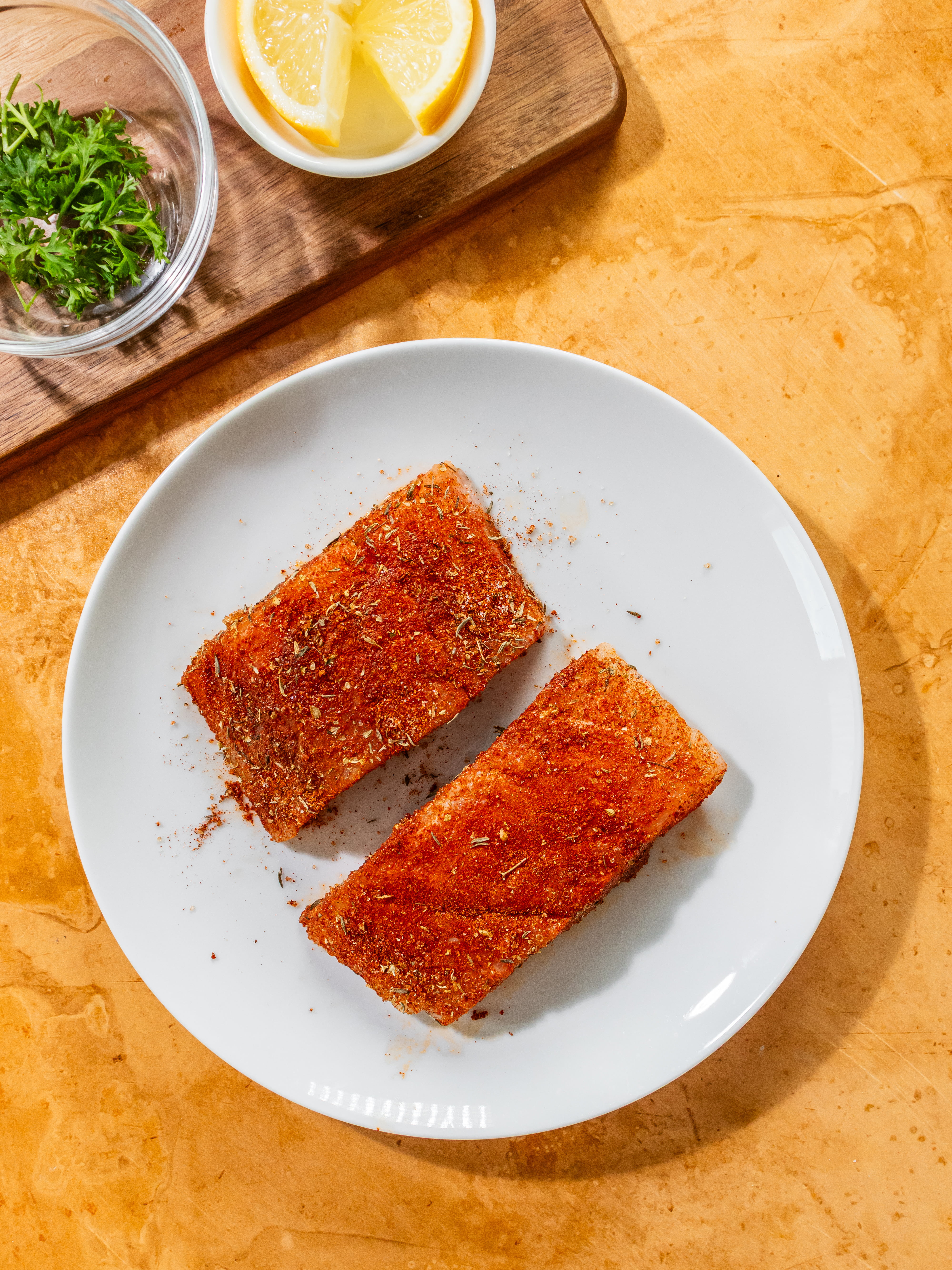Image of Generously rub the spice mixture on fish to coat.