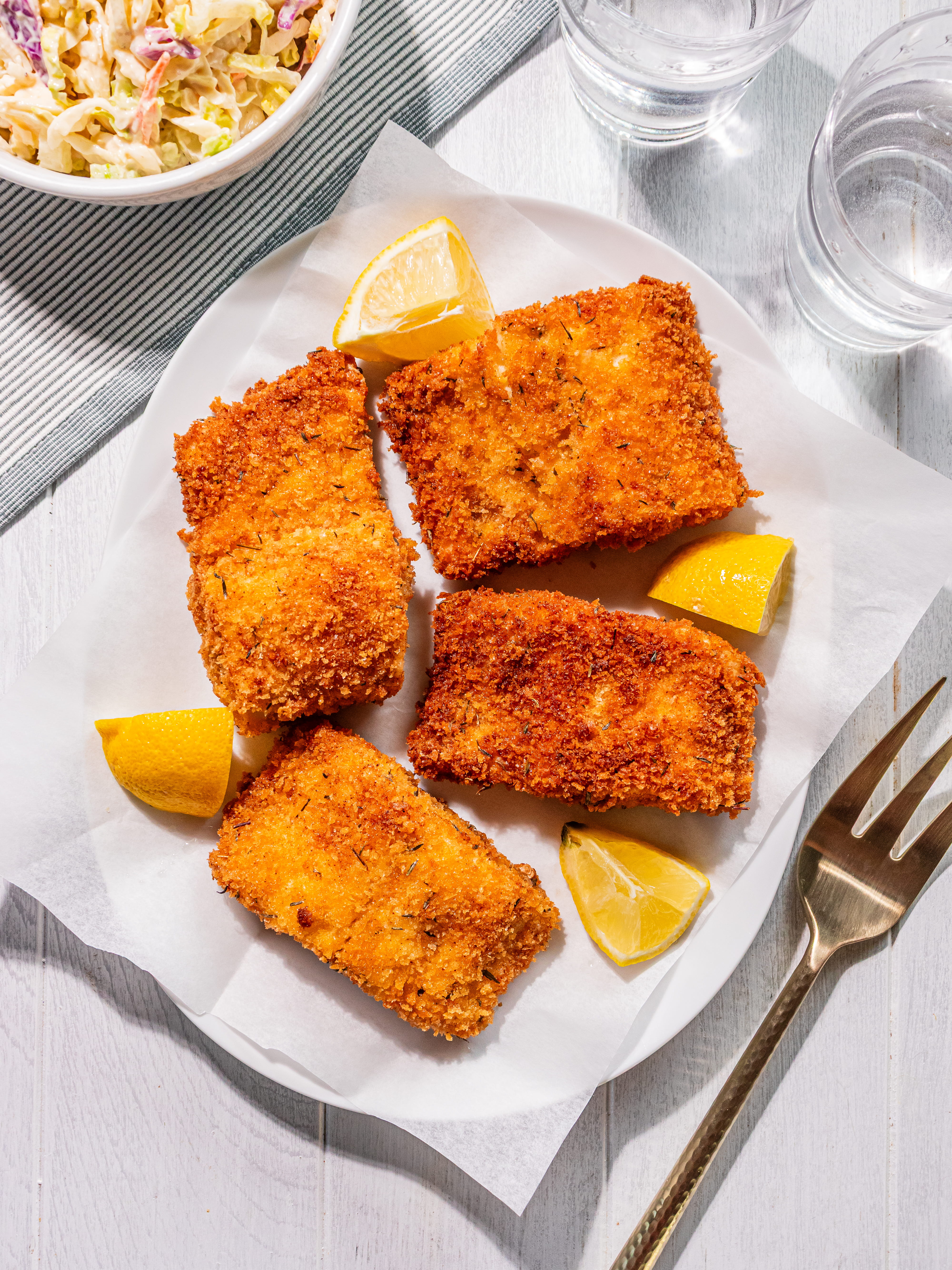 Image of Place cooked fish on paper towel lined plate. Repeat with...