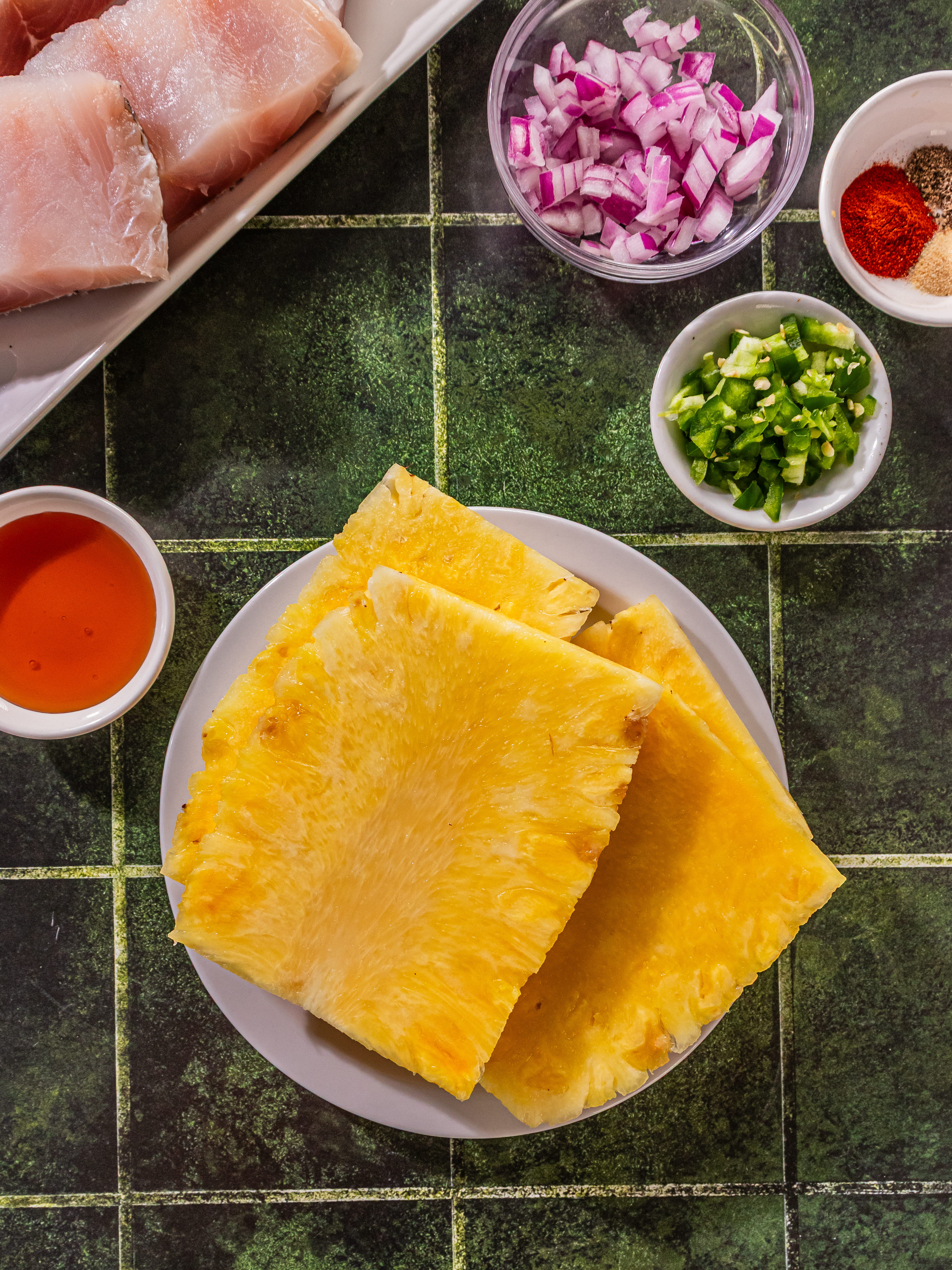Image of Slice and discard top, bottom, and sides of pineapple. Slice...