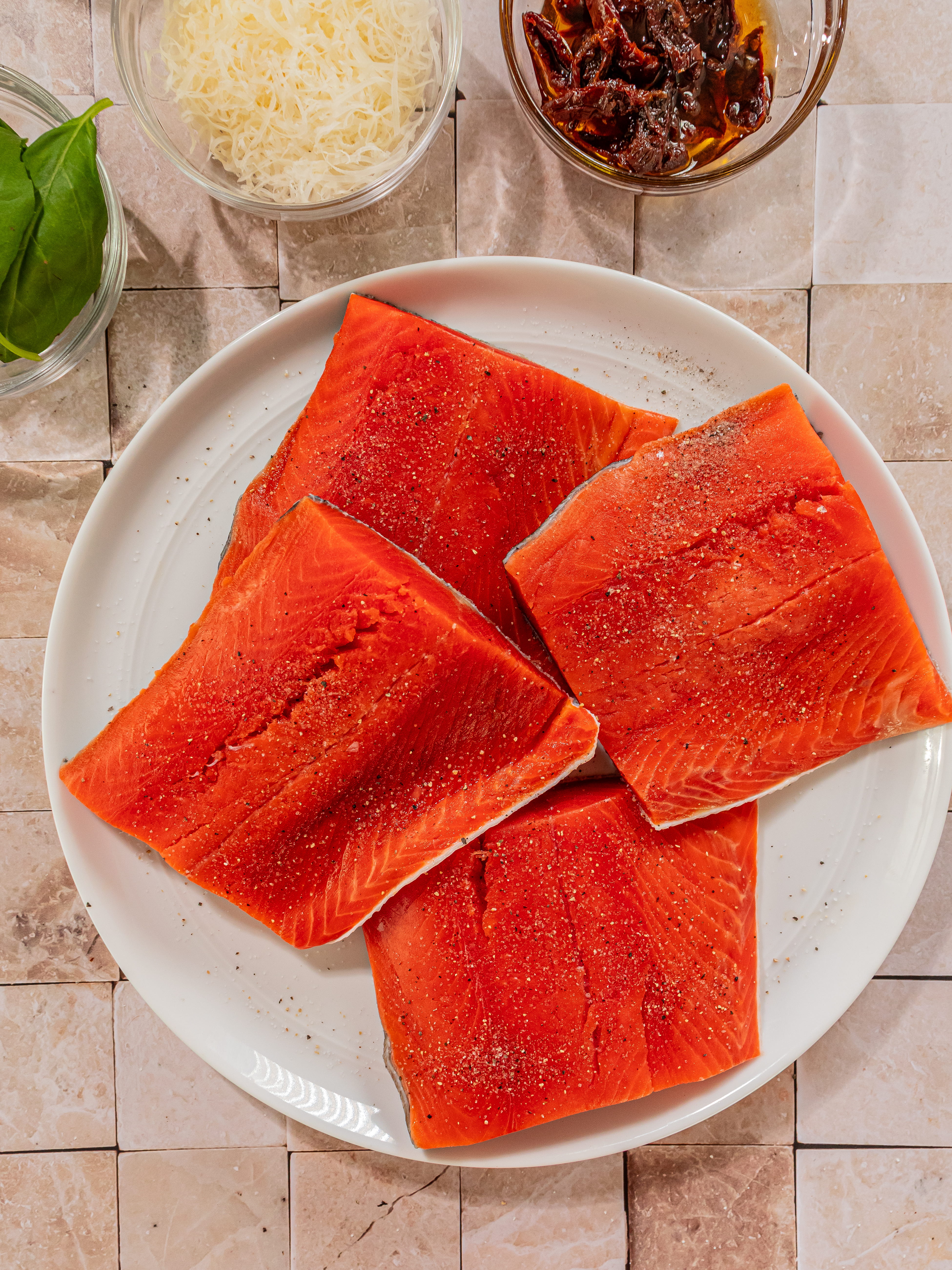 Image of Blot salmon with paper towels to remove excess moisture. Season...