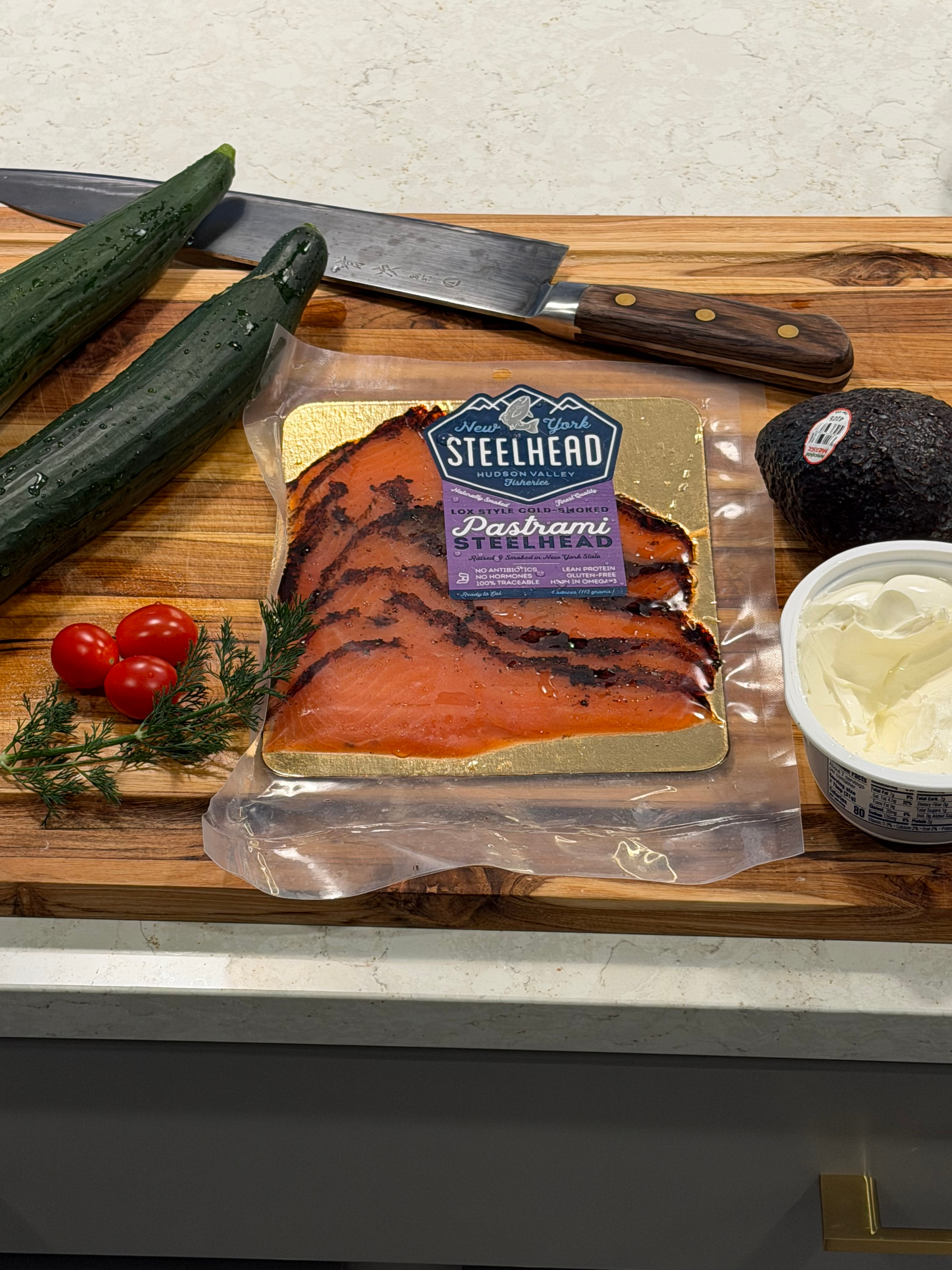 Image of Layer smoked lox pastrami evenly across the cucumber strips.