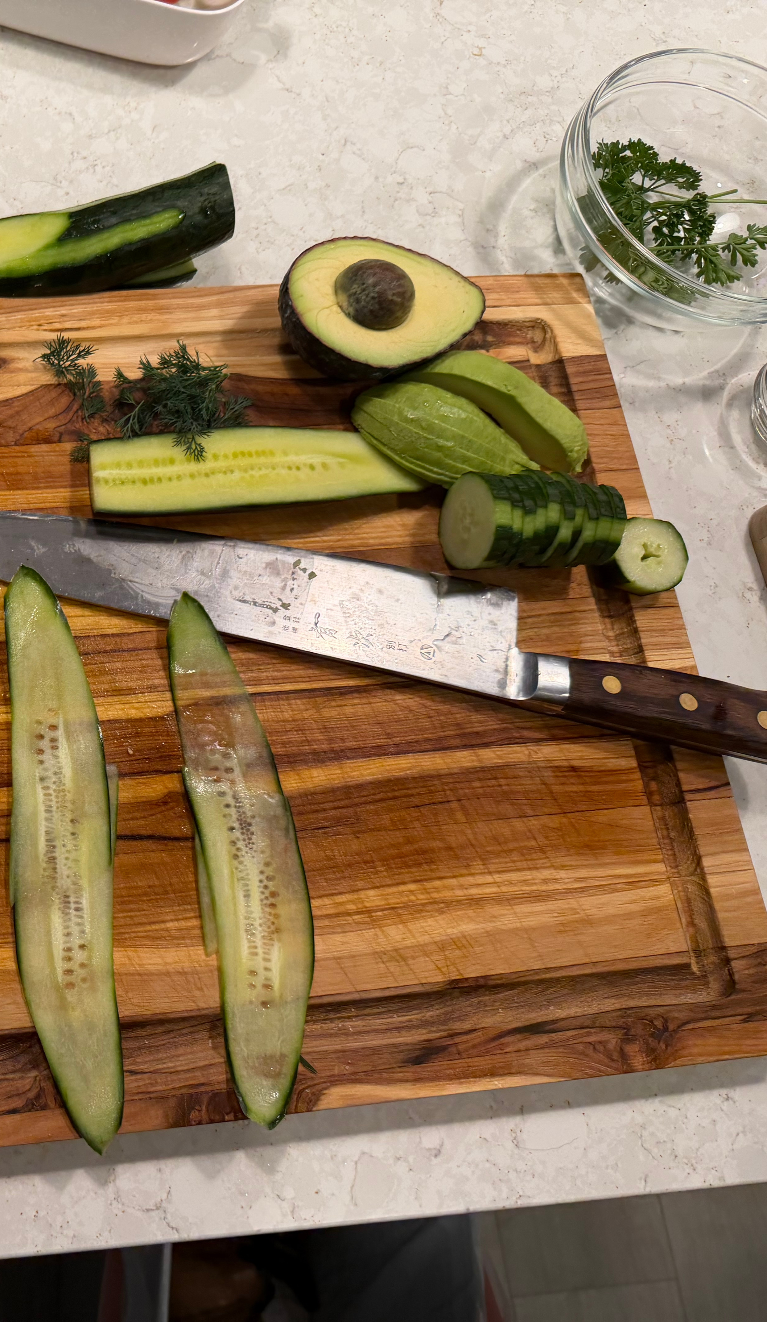 Image of Using a mandoline, slice the cucumber lengthwise into thin strips....