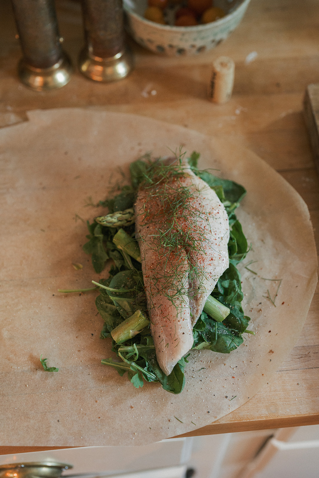 Image of Place a sea bass fillet on top of the vegetables.