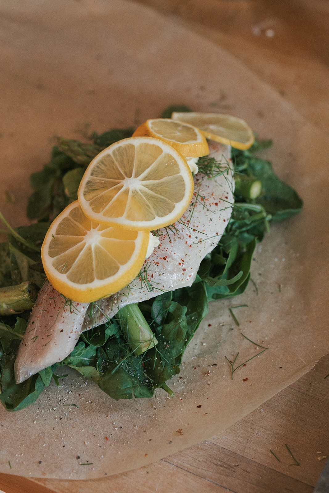 Image of Season the fish with salt and pepper. Top with lemon...