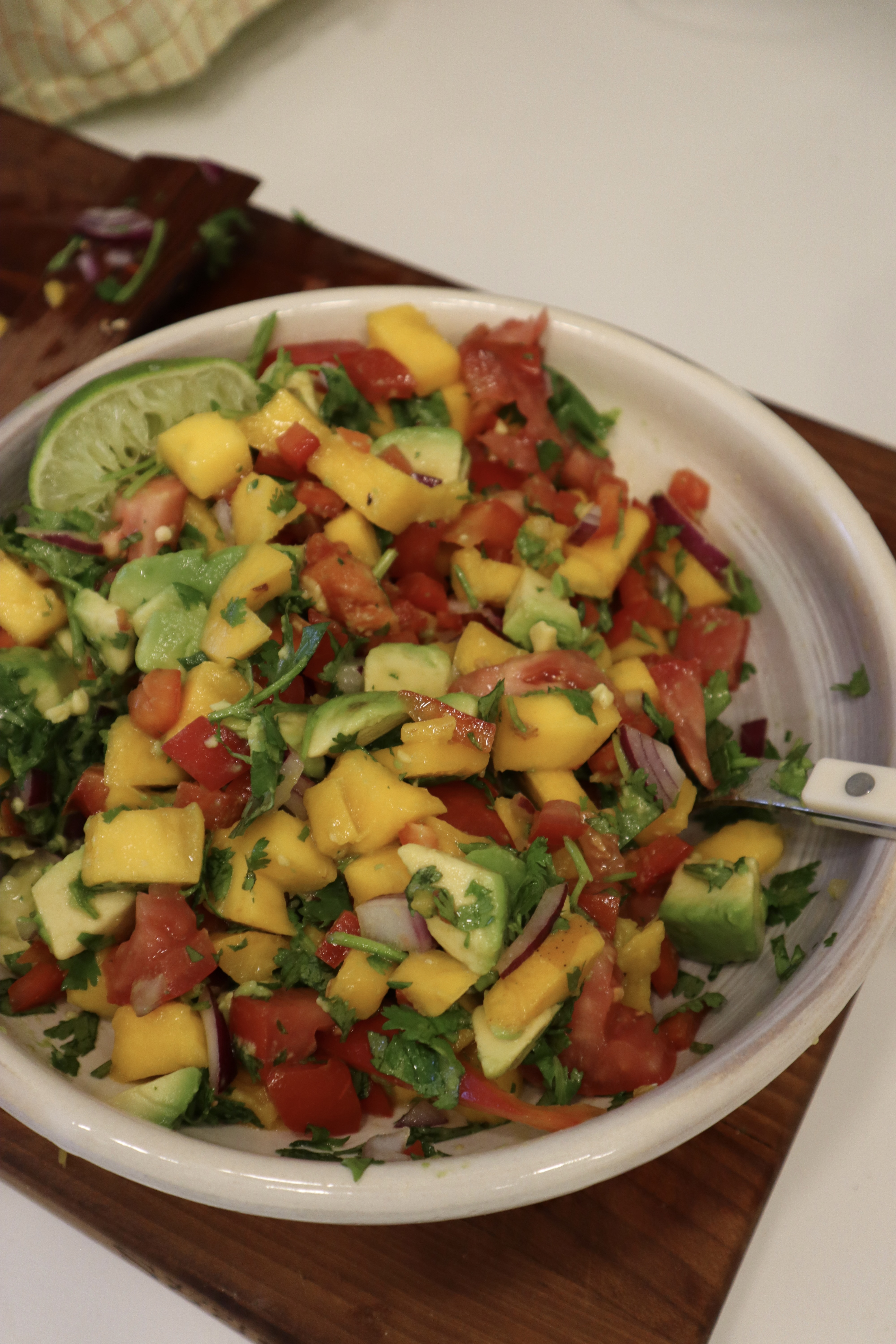 Image of Combine the mango, red bell pepper, red onion, tomato, jalapeño...