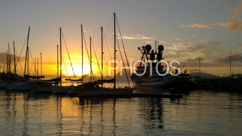 Sunset with sail Boats and yacht In Port Of Tahiti