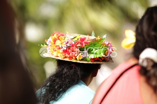 Tahitian woman with hat and flowers