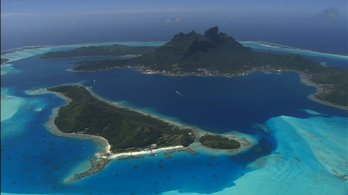 Aerial shot of the island of Bora Bora and its mountain, in French Polynesia
