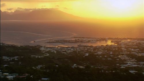 Aerial shot of town and port of Papeete by the sunset, Island of Tahiti in french Polynesia