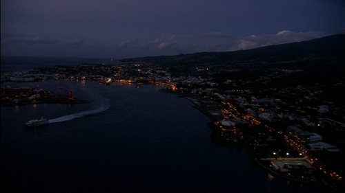 Aerial shot of town and port of Papeete by night, on Island of Tahiti in french Polynesia