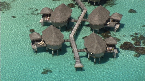 Tikehau, Aerial shot of overwater bungalows of luxury hotel in the lagoon