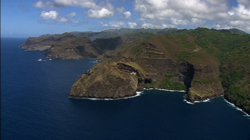 Aerial shot of the flying along the oceanic coast and mountains of Nuku Hiva in french Polynesia