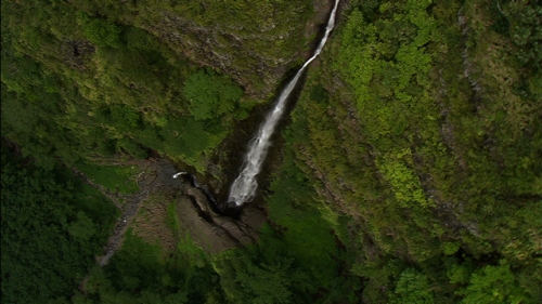 Vertical aerial shot of waterfall in the Tapivai valley of Nuku Hiva, Marquesas Archipelago in french Polynesia