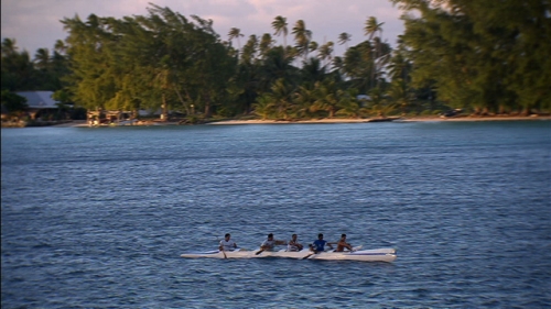 Aerial shot of five paddlers in a polynesian canoe, lagoon of Fakarava in Tuamotus archipelago, french Polynesia