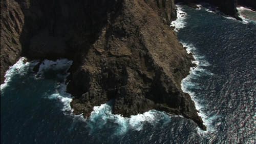 Aerial shot of the rocky coast of island Ua Pou, Marquesas archipelago in french Polynesia, camera mouvment up