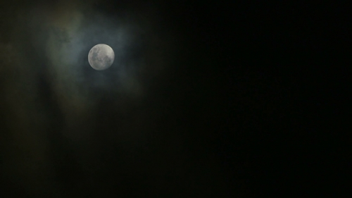 Bora Bora,  Moon disappearing behing clouds at night