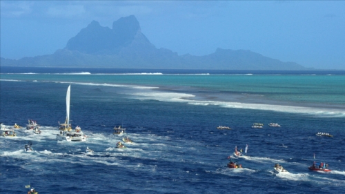 4K UHD, Bora Bora island, Aerial, boats and polynesian canoes on the ocean side