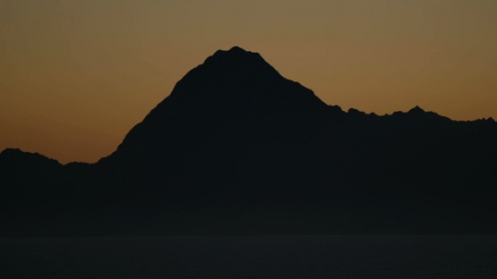 Moorea, panoramic view of nice sunset on the mountain chain of the island, shot from Tahiti