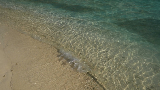 Slowmotion, waves of the lagoon breaking on the beach