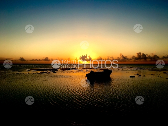 Fishingboat in the lagoon of Hauru, Moorea, during sunset