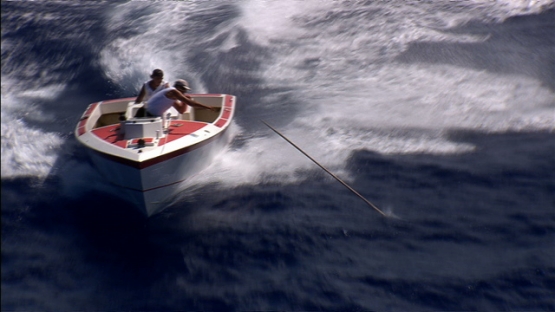 Maupiti, fishing boat in the ocean, harpooning a mahi mahi in the swell